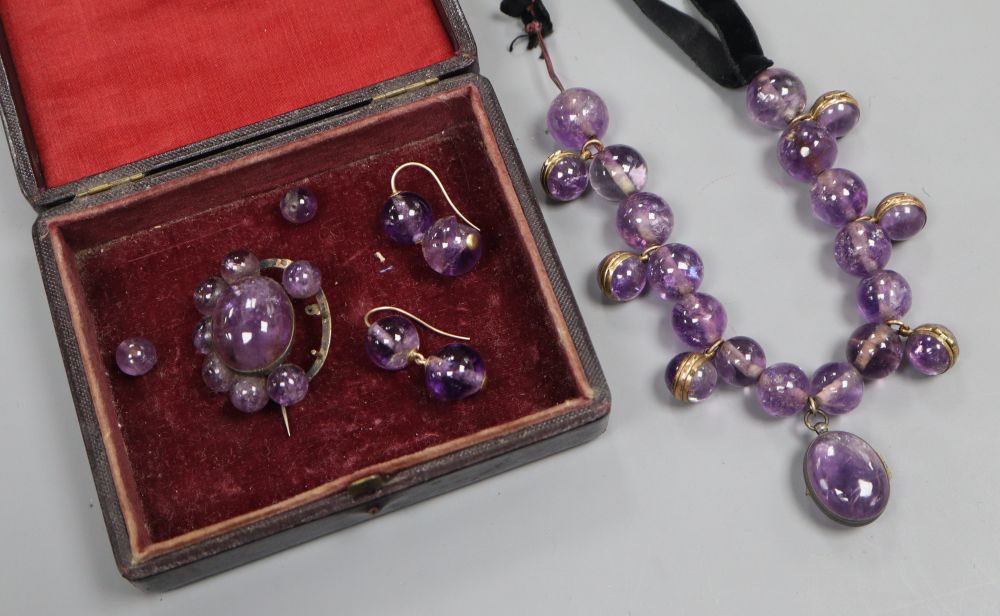 A Victorian amethyst bead and black sash necklace, (quartz section 21cm) and a similar brooch and pair of earrings (a.f.).